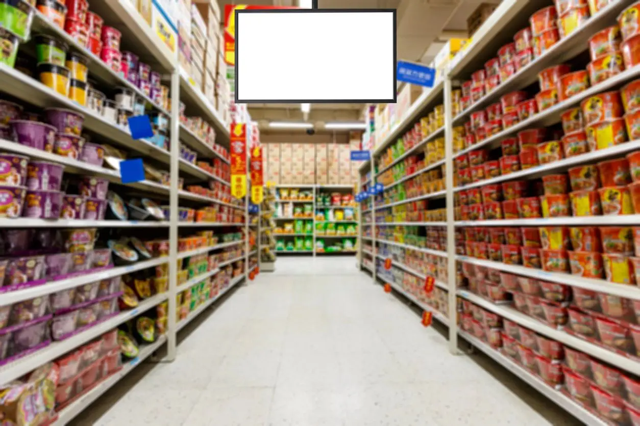 A store aisle with many shelves of food and drinks.